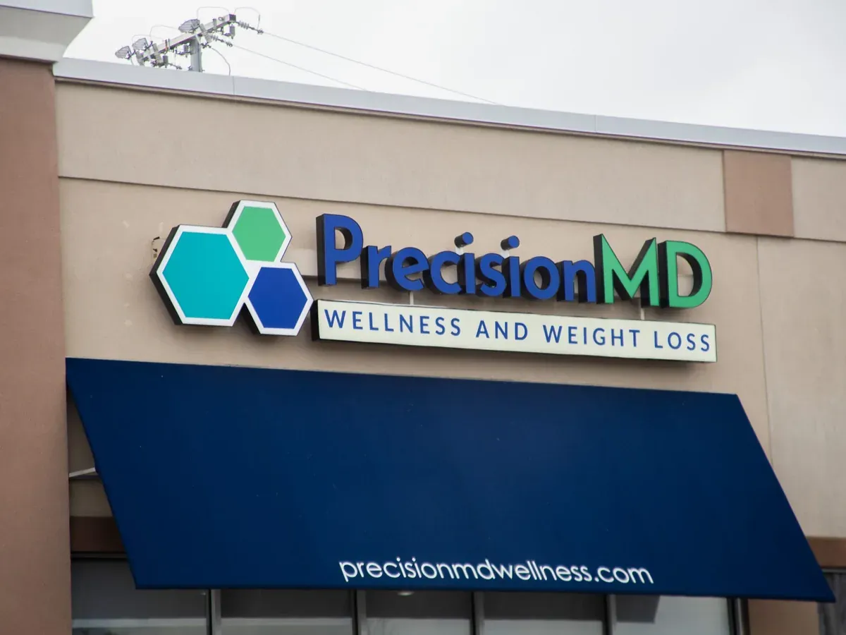 The PrecisionMD Wellness and Weight Loss sign over a clinic entrance
