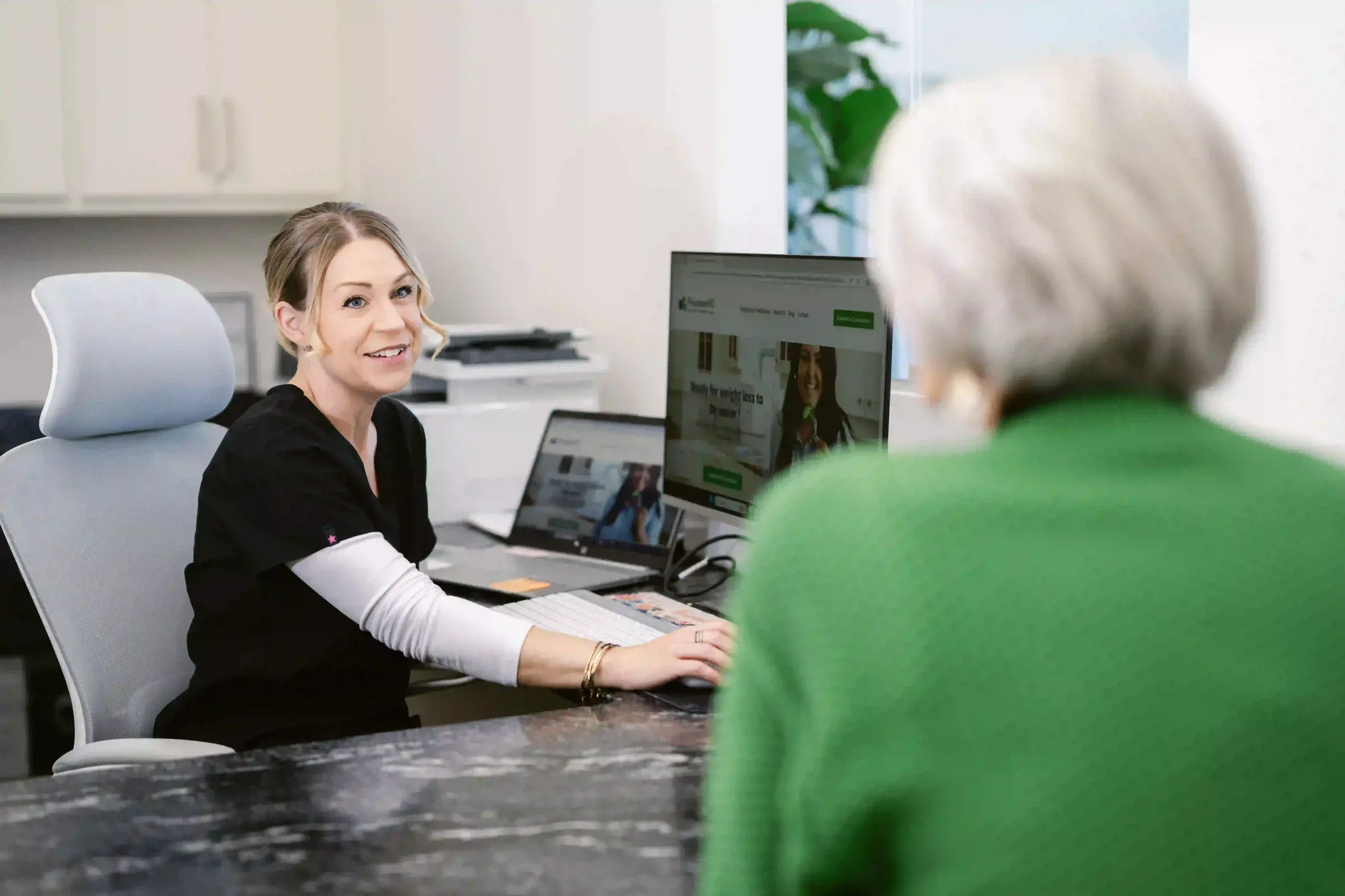 A provider reviewing results with a patient at her desk